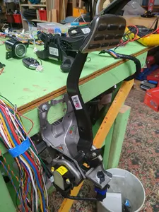 Brake pedal mounted upside down to side of bench