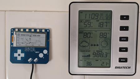 Badge with solar_usage app next to weather station on the wall